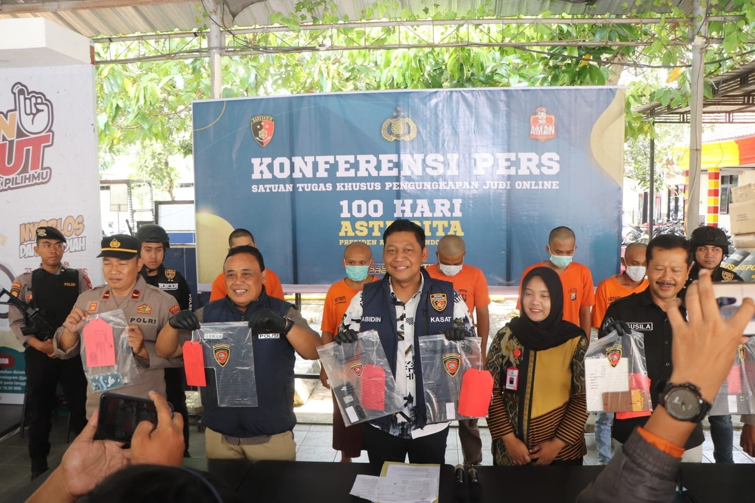 "Enam tersangka judi online, termasuk selebgram, saat dihadirkan dalam konferensi pers oleh Polres Trenggalek."